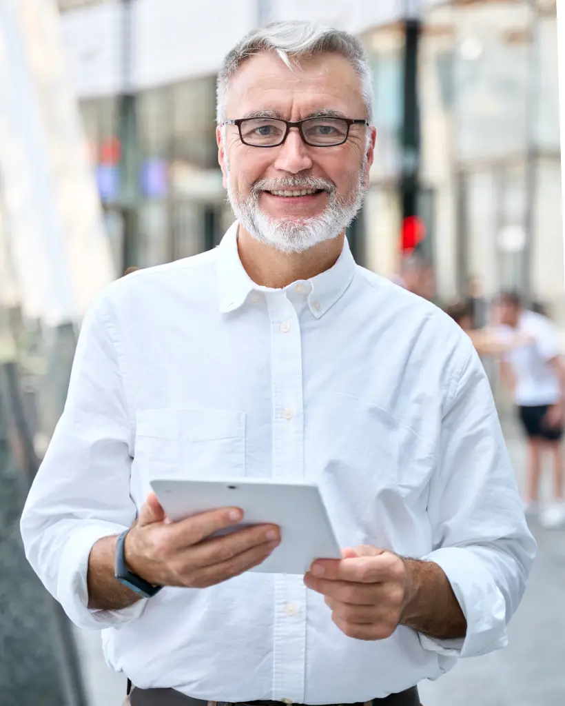 older senior professional business man using digit 6UKKT3E
